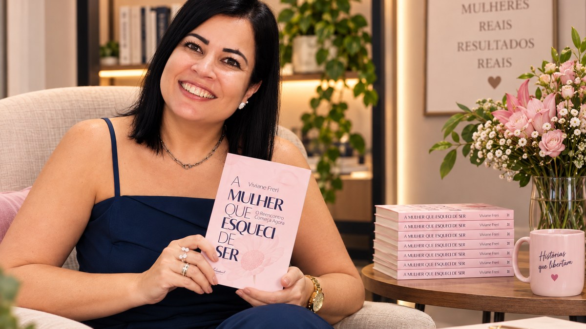 Vivi Freri sentada na poltrona segurando o livro A Mulher Que Esqueci de Ser
